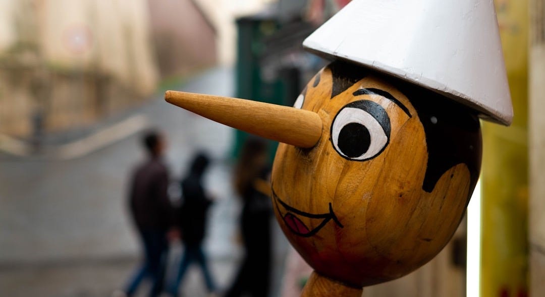 a wooden statue with a white hat on top of it a wooden statue with a white hat on top of it
