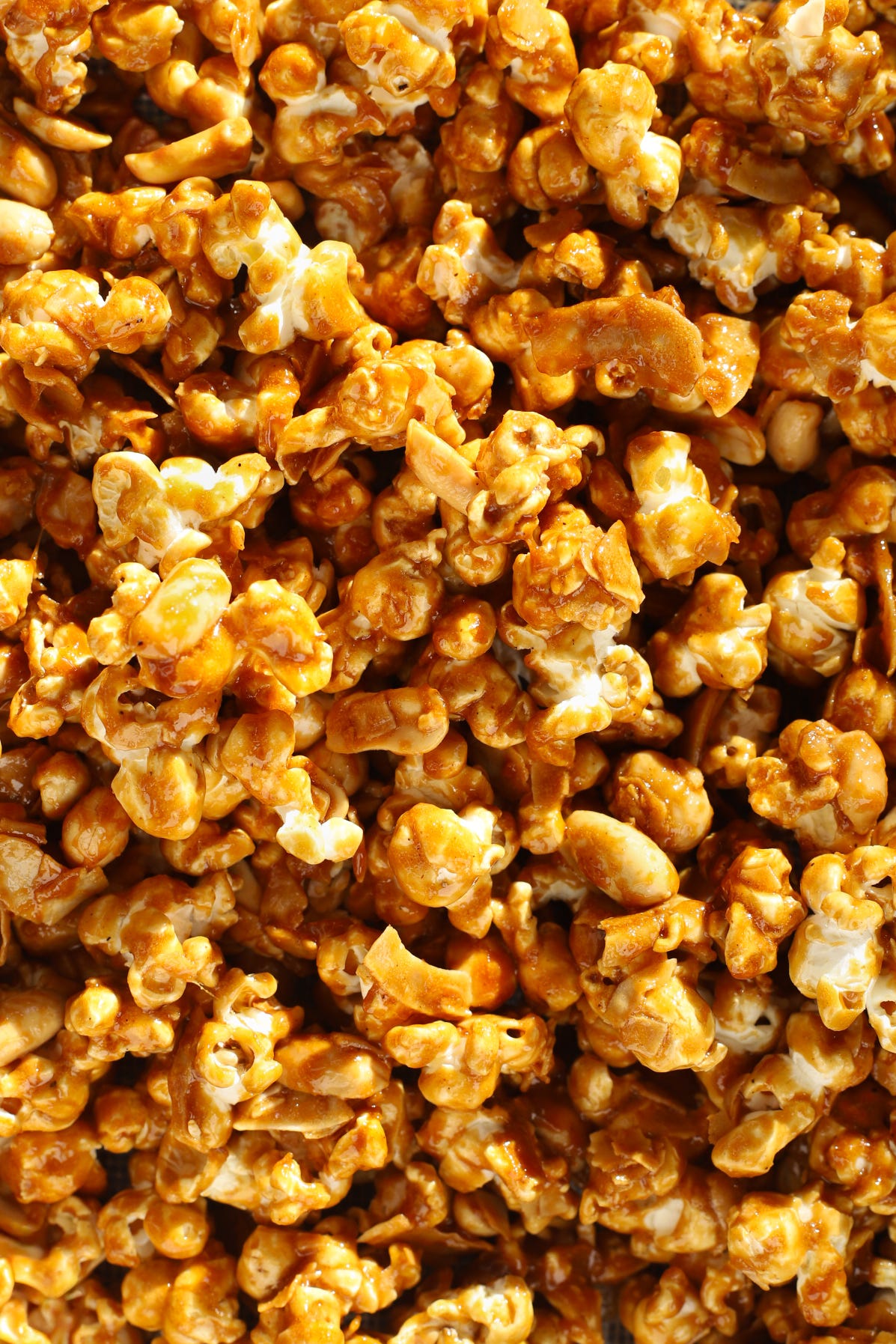 Close-up of caramel corn with peanuts and coconut flakes