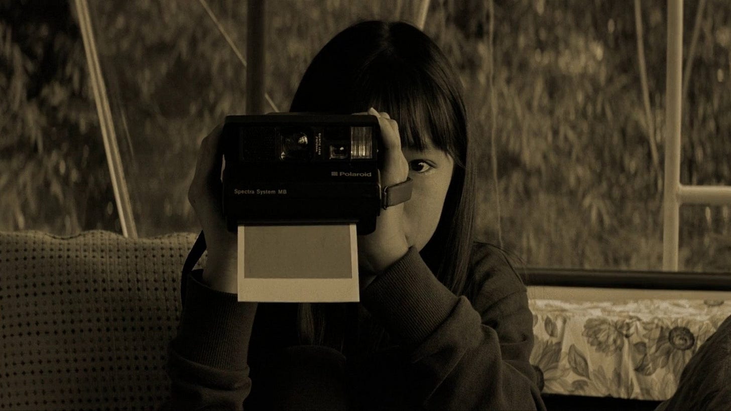 Eureka | Still features a young girl taking a polaroid photo.
