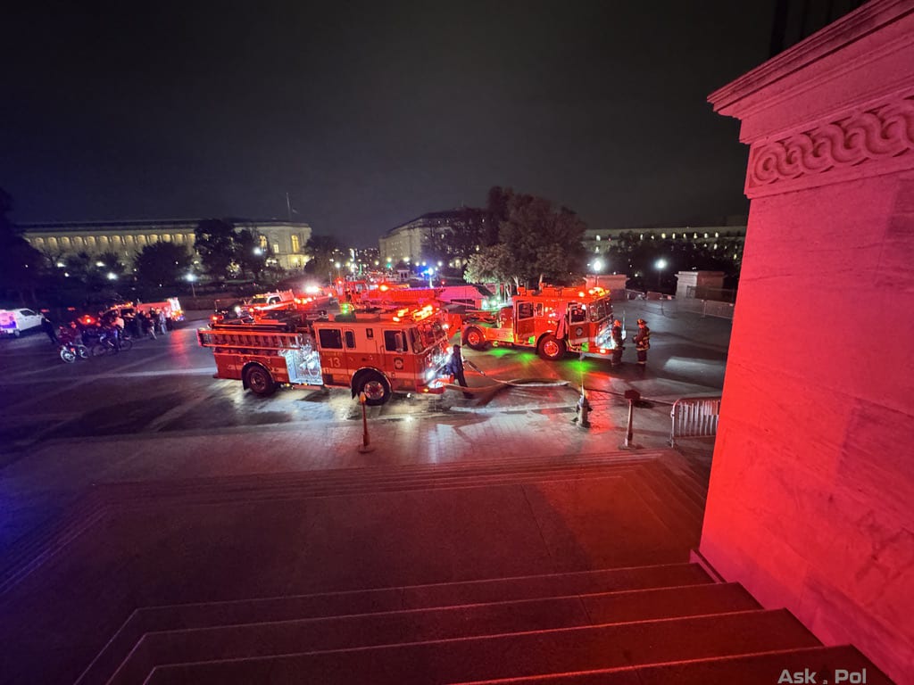 Large red fire engines are parked outside the US Capitol, lights flashing as firefighters fight a fire on an underground tram. Photo: Matt Laslo © www.askapol.com Large red fire engines are parked outside the US Capitol, lights flashing as firefighters fight a fire on an underground tram. Photo: Matt Laslo © www.askapol.com