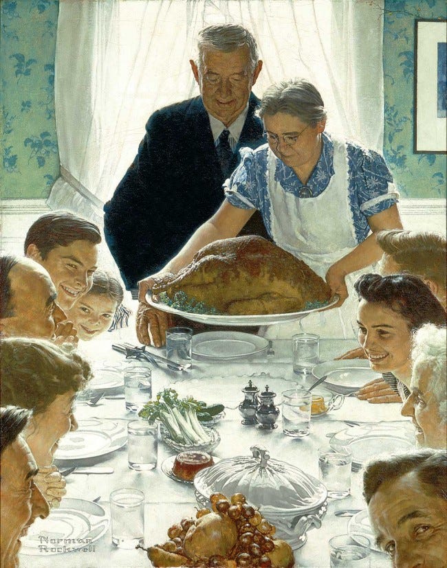 A woman setting a roast turkey on a white tablecloth before a family seated around the table