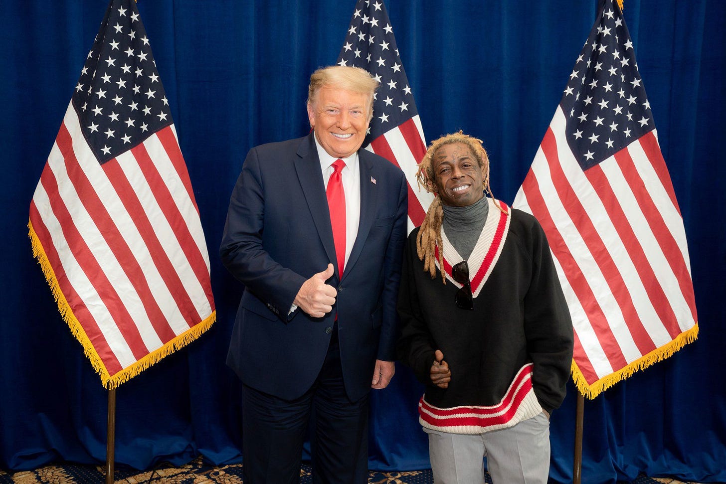 A person giving a thumbs up with a person in front of a flag

AI-generated content may be incorrect.