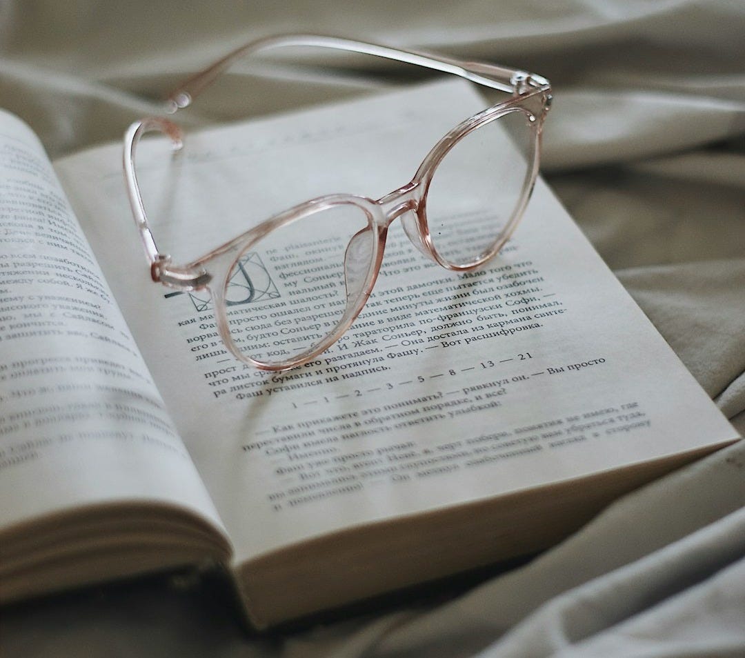silver framed eyeglasses on book page