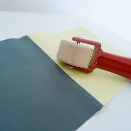a wooden seam roller resting on a table