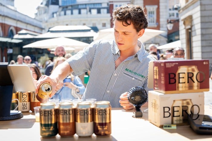 Tom Holland serving BERO beer at a BERO x Shopify pop-up event in Covent Garden.