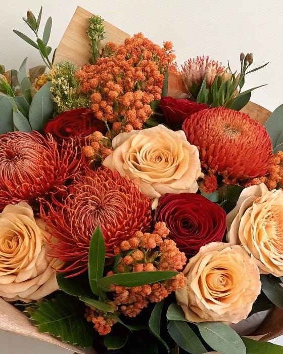 This may contain: a bouquet of flowers sitting on top of a table