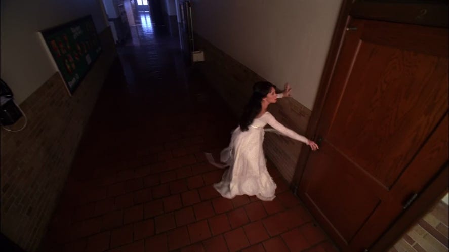 Jennifer Love Hewitt as Melinda Gordon runs through a hallway in a dream dressed in a floor-length white nightgown