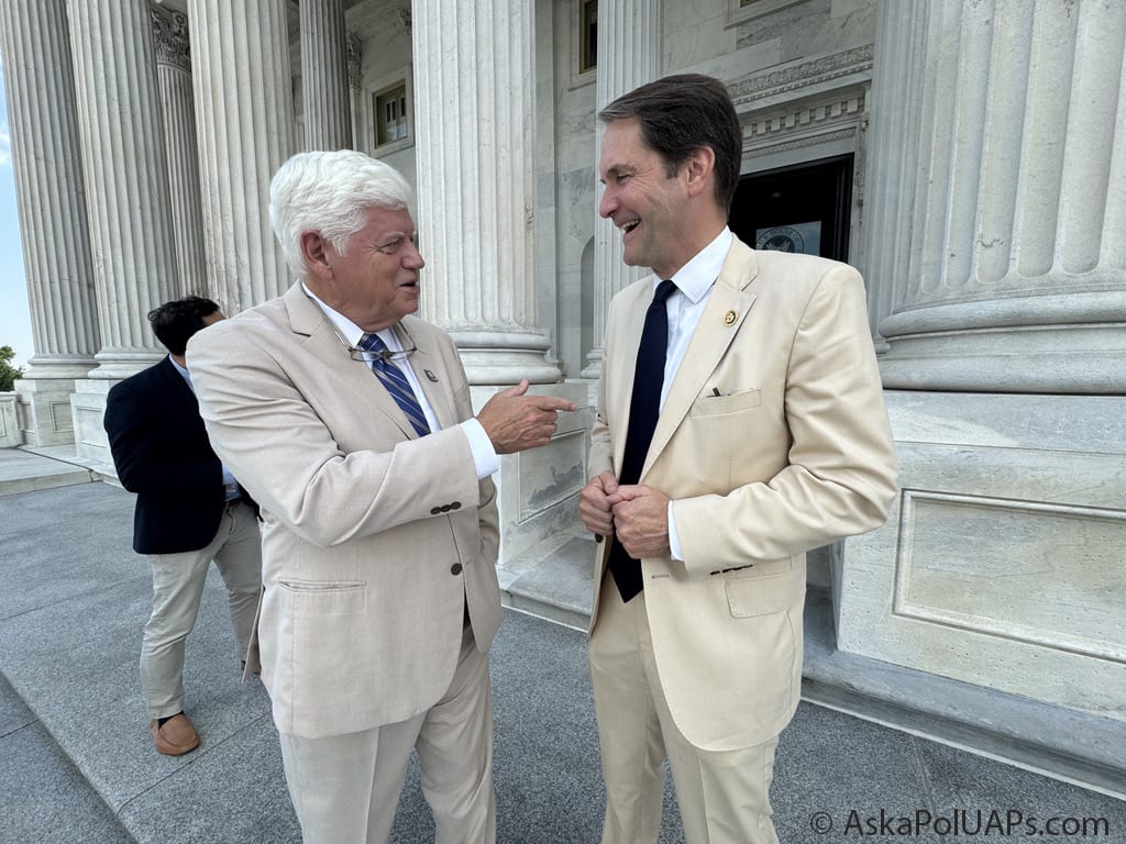Two men in summer suits chat with columns in back of them © AskaPol.com Two men in summer suits chat with columns in back of them © AskaPol.com