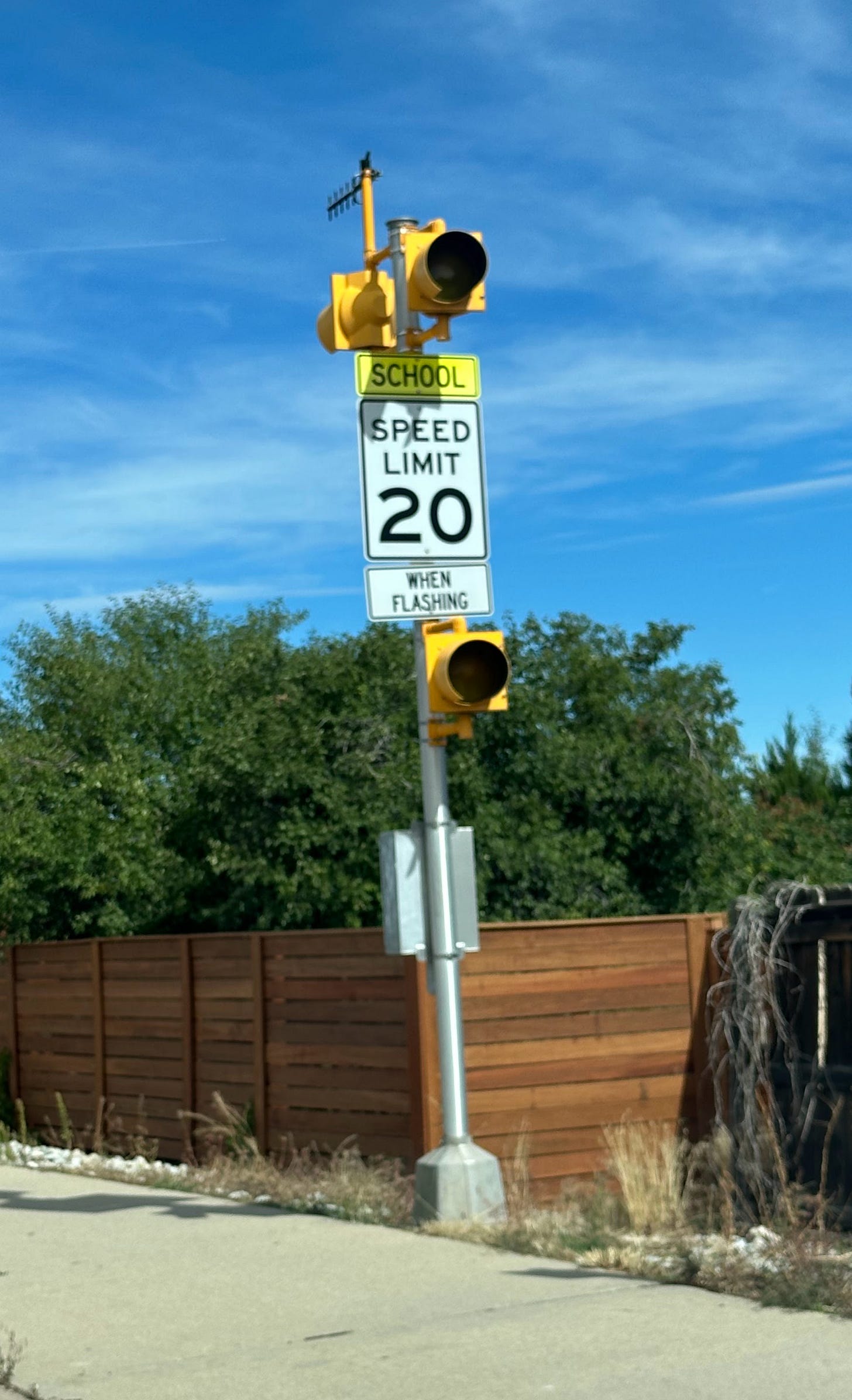 Photo of the speed detection device. It includes lights and a sign "School Speed limit 20 when flashing".