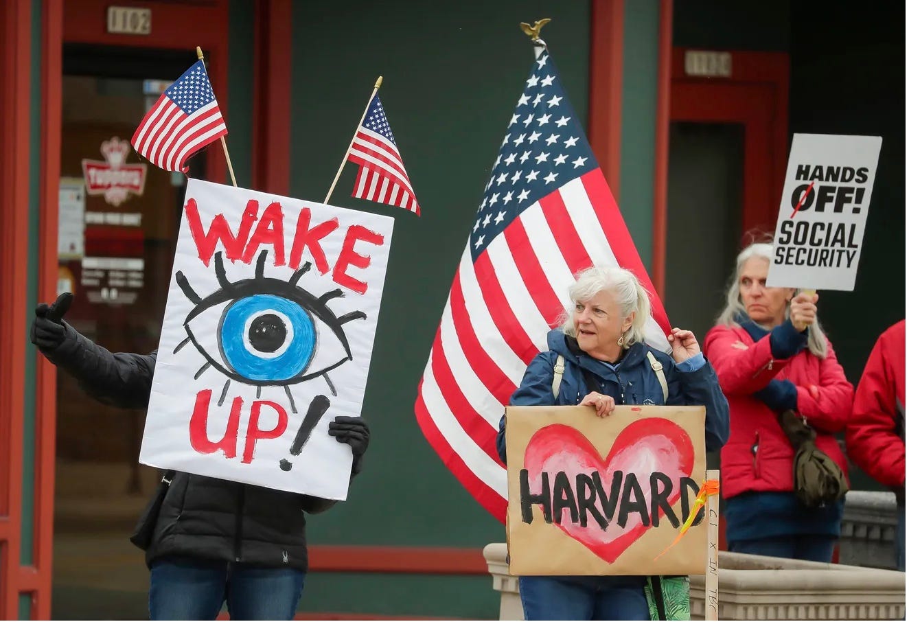 A group of people holding signs

AI-generated content may be incorrect.