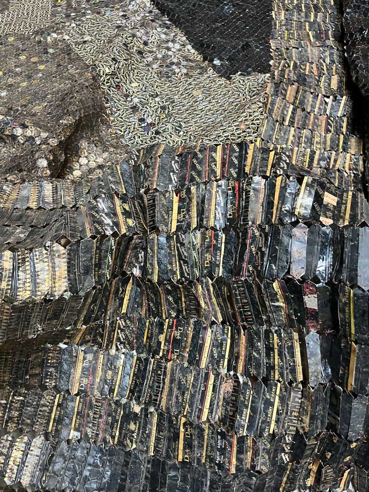 A detail of artwork made from fragments of metal joined by wire