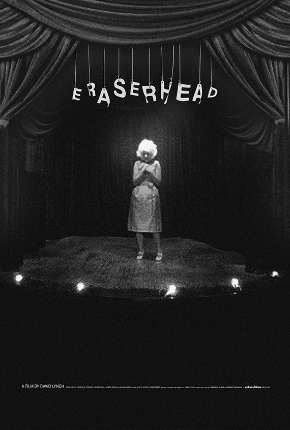 This may contain: a black and white photo of a woman standing on stage with the words erasehead above her head