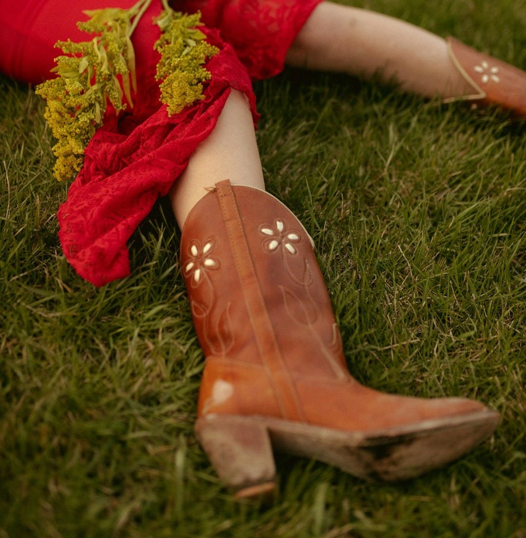 a woman in a red dress sitting on the grass a woman in a red dress sitting on the grass