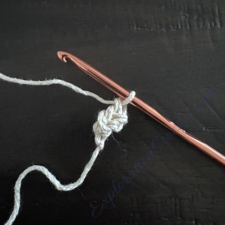 A crochet hook with a thread

Description automatically generated