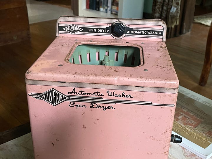 pink tin sink, sideboard, washing machine, and refrigerator in child sizes