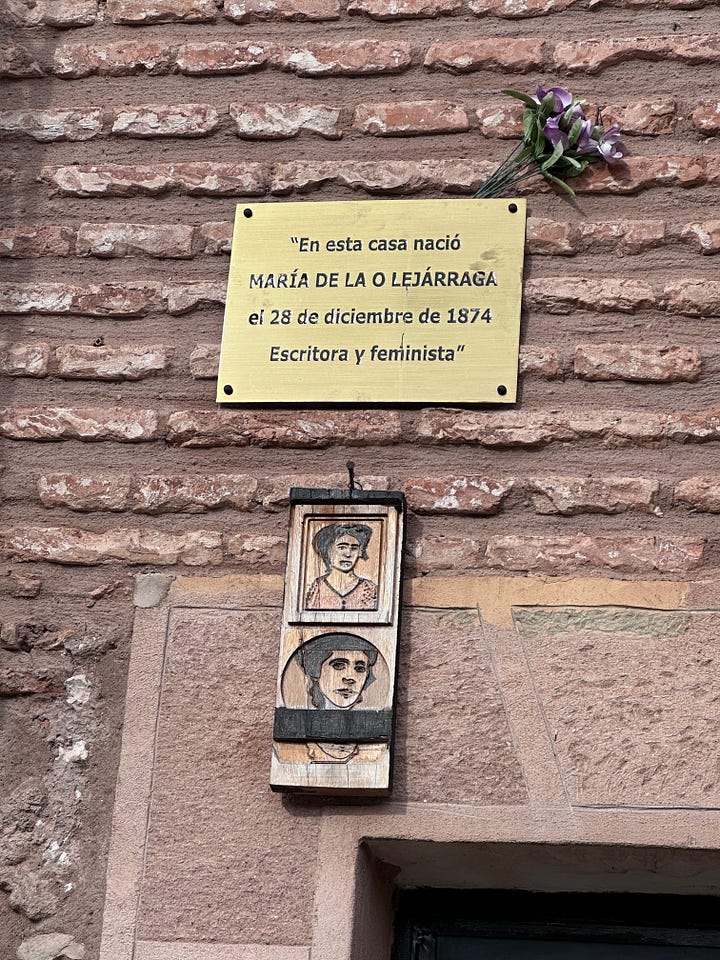 A mural with a quote from María and a plaque on the house she was born in.