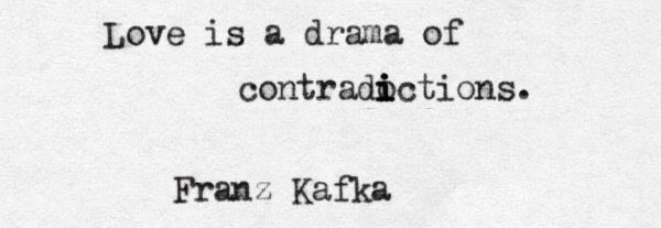 This may contain: an old typewriter with the words love is a drama of contraptions franz kafka