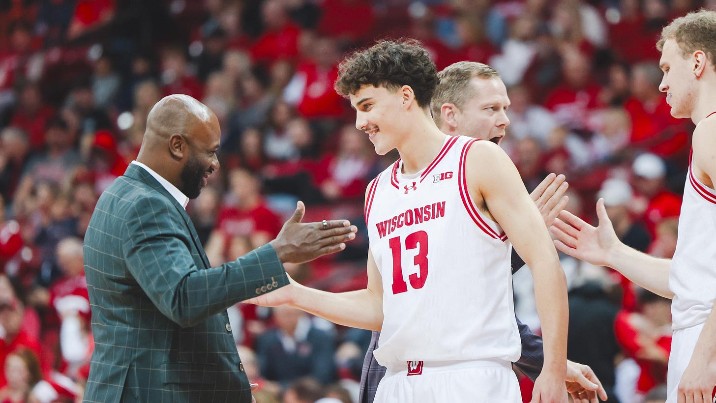 Wisconsin Badgers guard Hayden Jones shakes hands with assistant coach Sharif Chambliss. Photo credit: Dane Sheehan. Wisconsin Badgers guard Hayden Jones shakes hands with assistant coach Sharif Chambliss. Photo credit: Dane Sheehan.