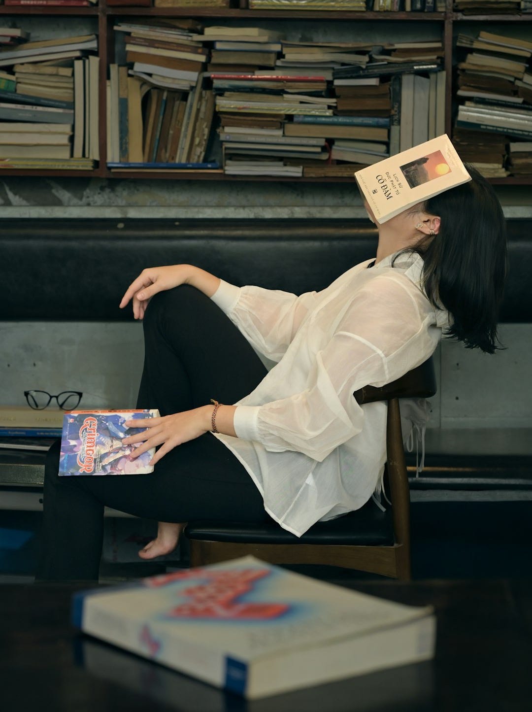 Woman sleeping with book on her face