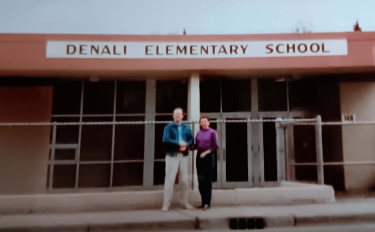 Mike and Mary of the Anchorage Memories Club in front of Denali Elementary school, in Anchorage, Alaska circa 1990s.