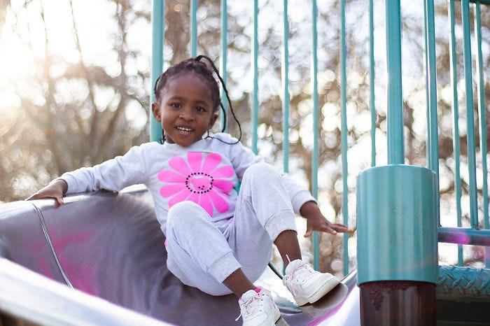 Little girl on playground apparatus