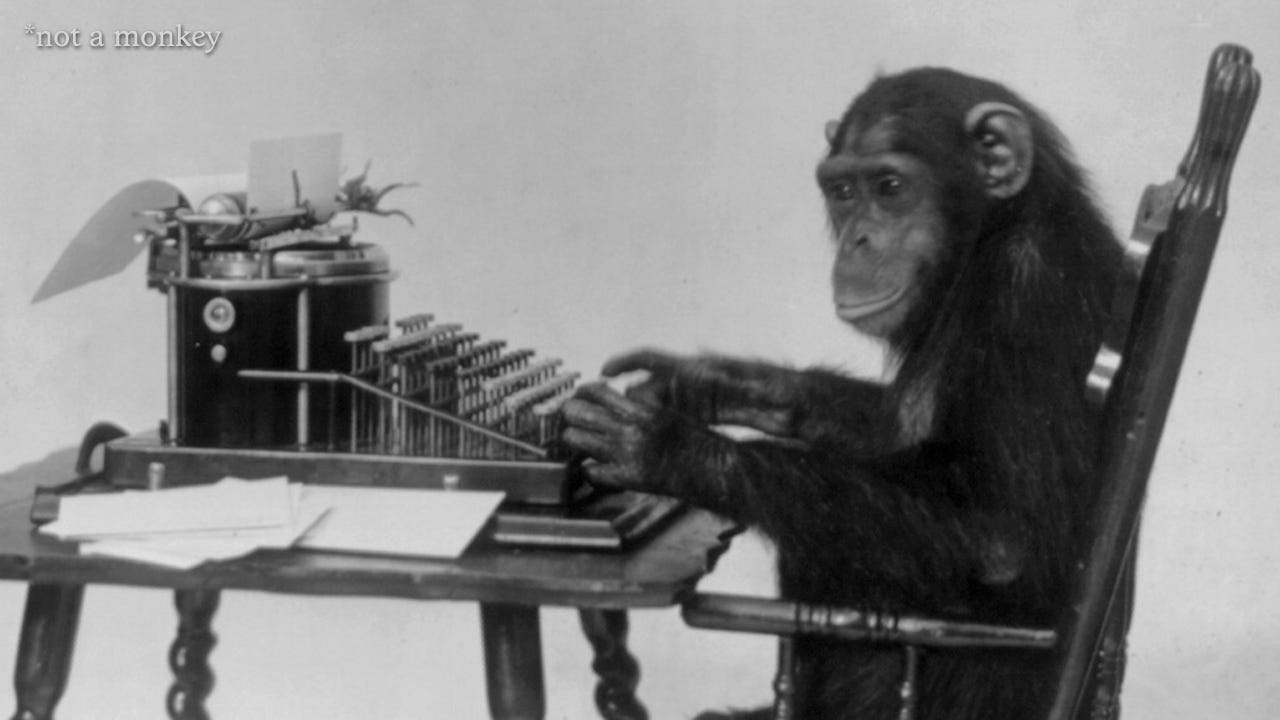 Chimpanzee, and not a monkey, at a typewriter.