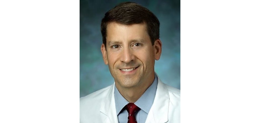 Medium shot of a person wearing a white coat

AI-generated content may be incorrect.