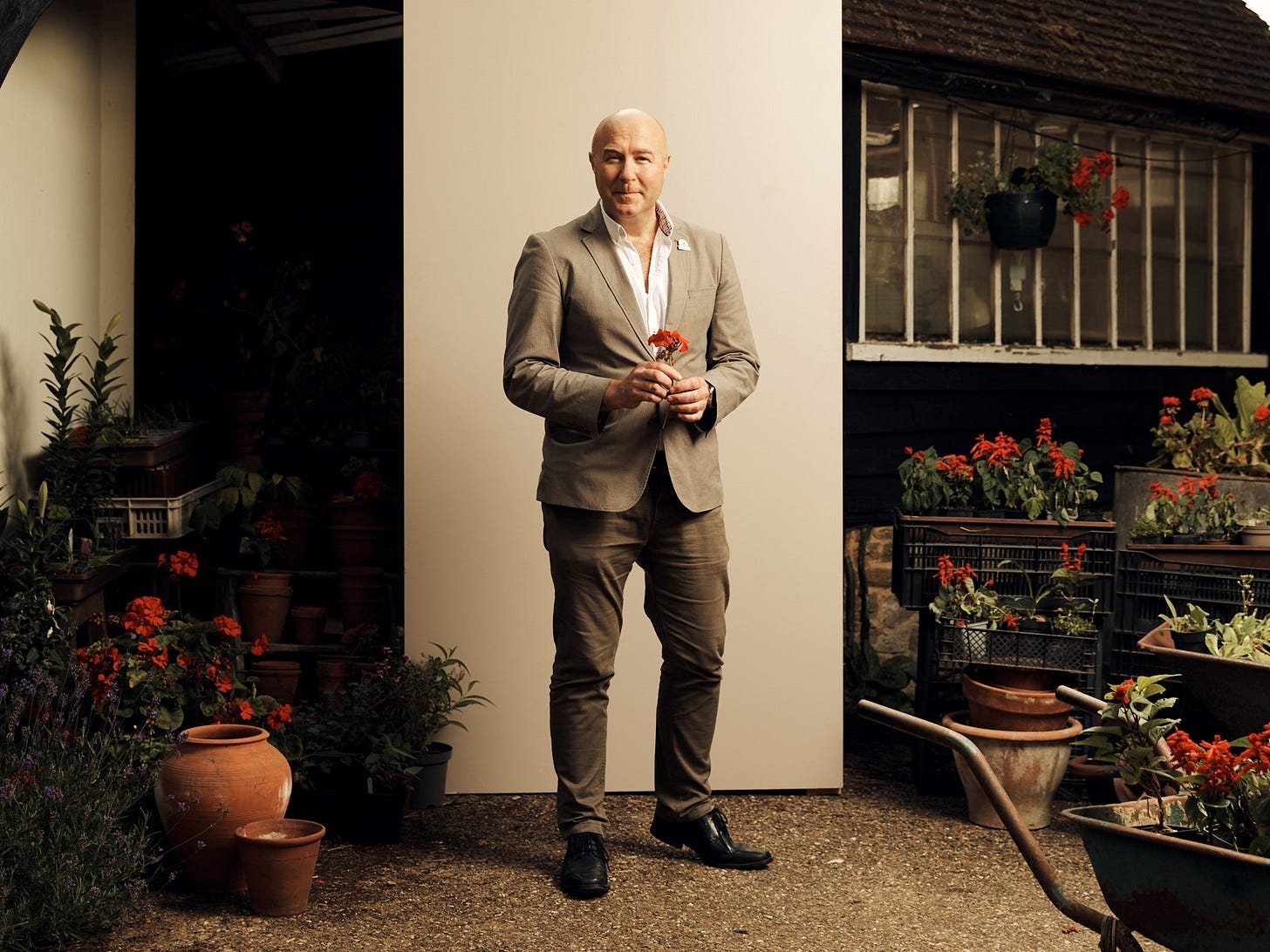 Portrait photo of Andy Jasper surrounded by flowers