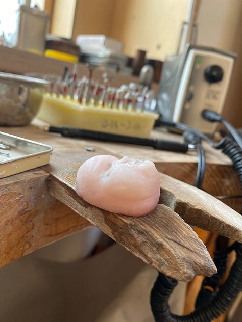 man carved out of pink opal