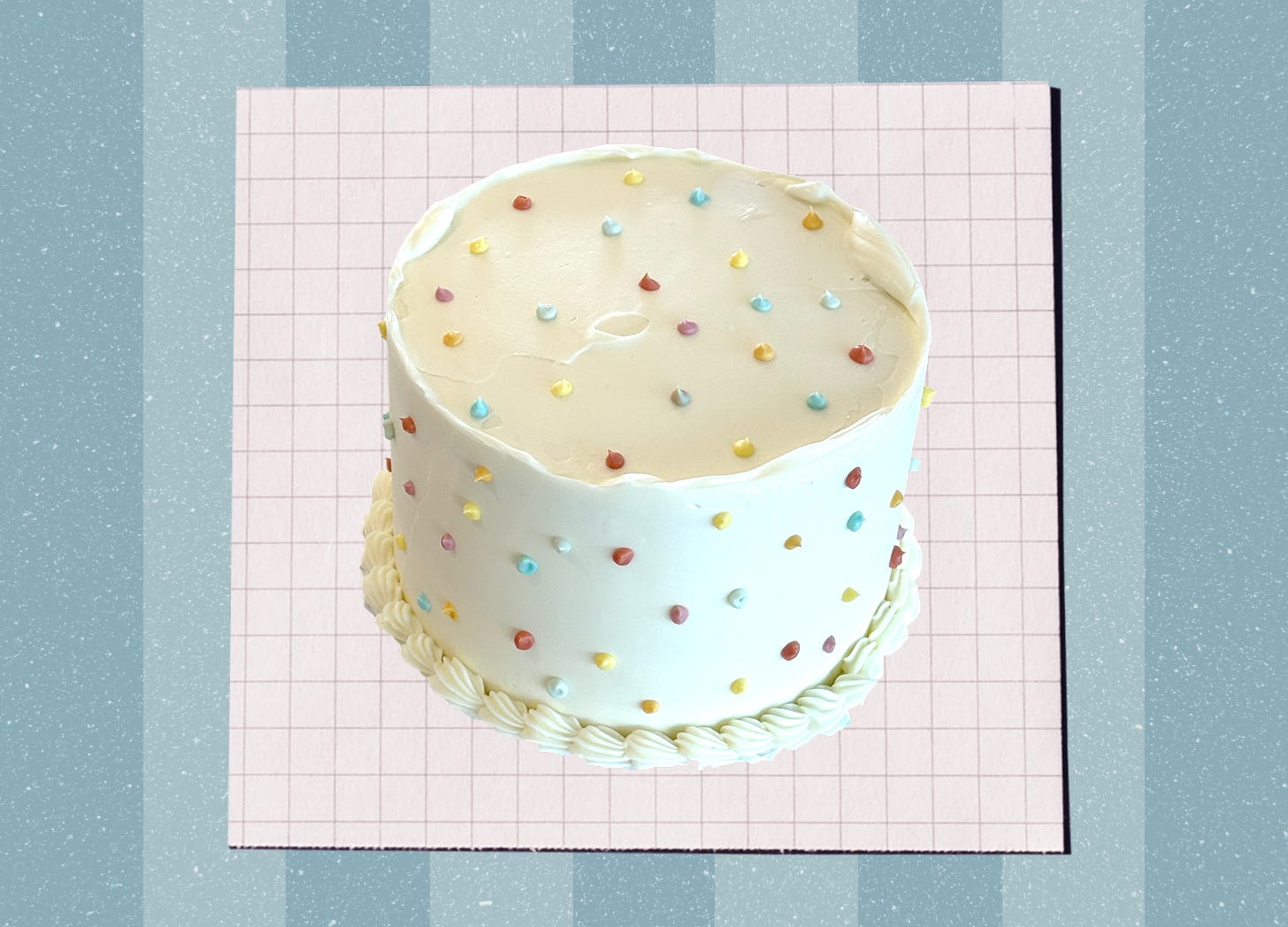 A birthday cake with white frosting and vintage piping, and colorful dots piped along the top and sides.