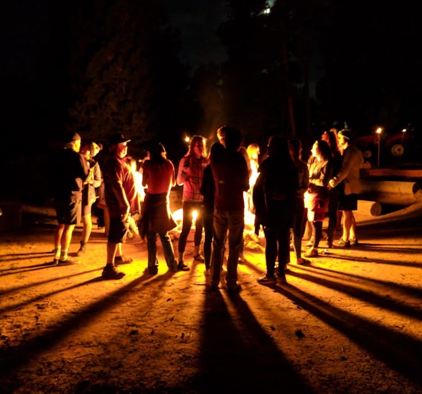 group of people walking on road during nighttime