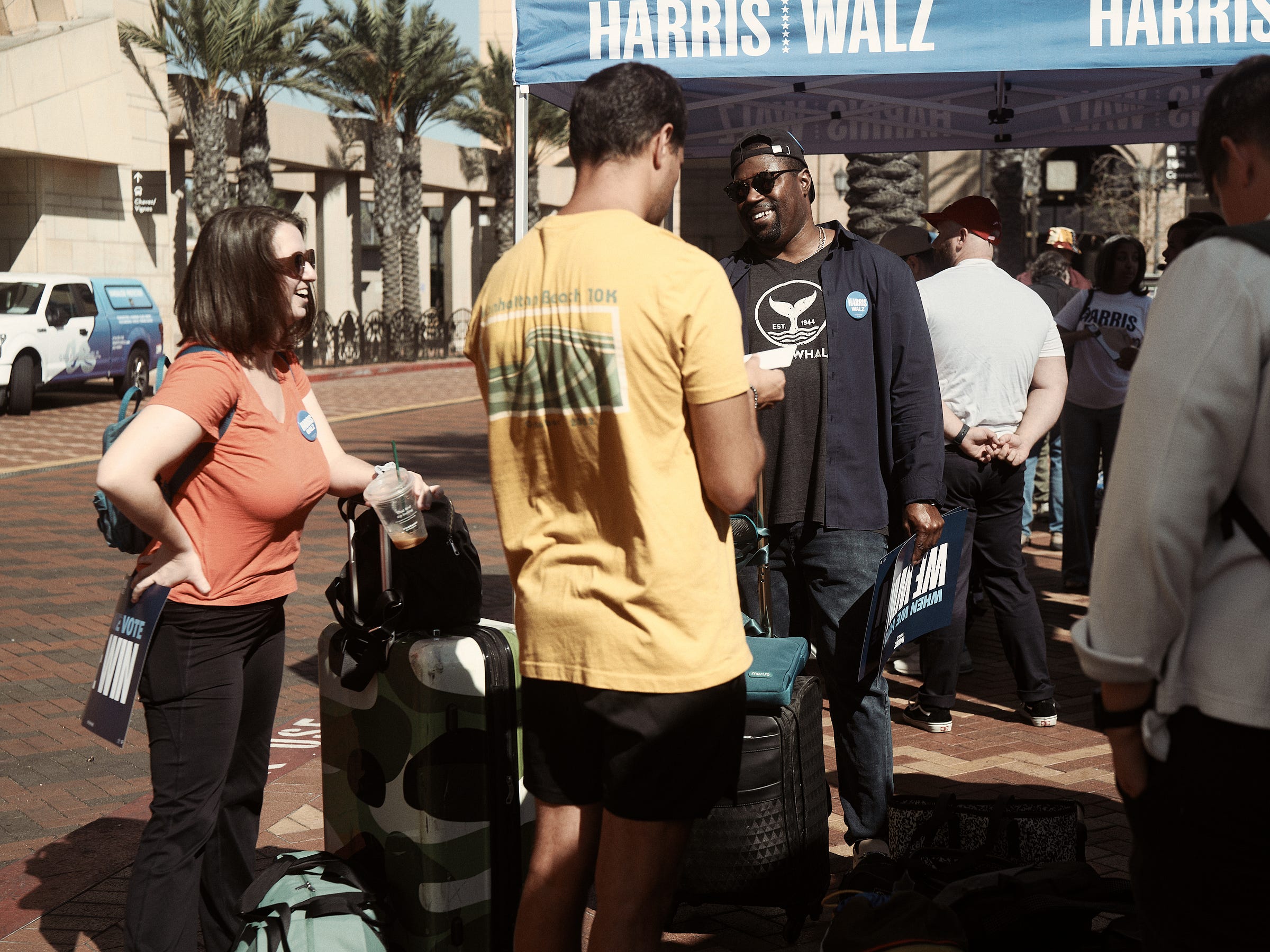 Kelsey and other volunteers gather around the check-in base with their luggage ready for the weekend canvassing in Phoenix, AZ, by Los Angeles photographer Afonso Salcedo