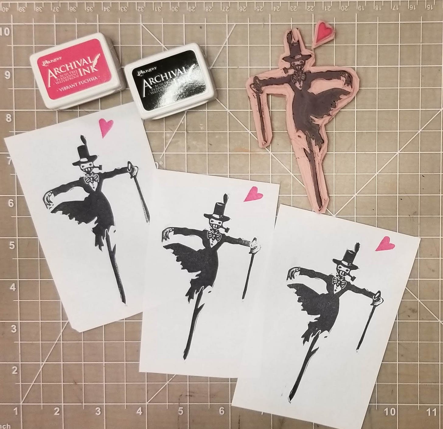 hand-carved stamp of Turnip Head from Howl's Moving Castle next to two ink pads and three sample prints