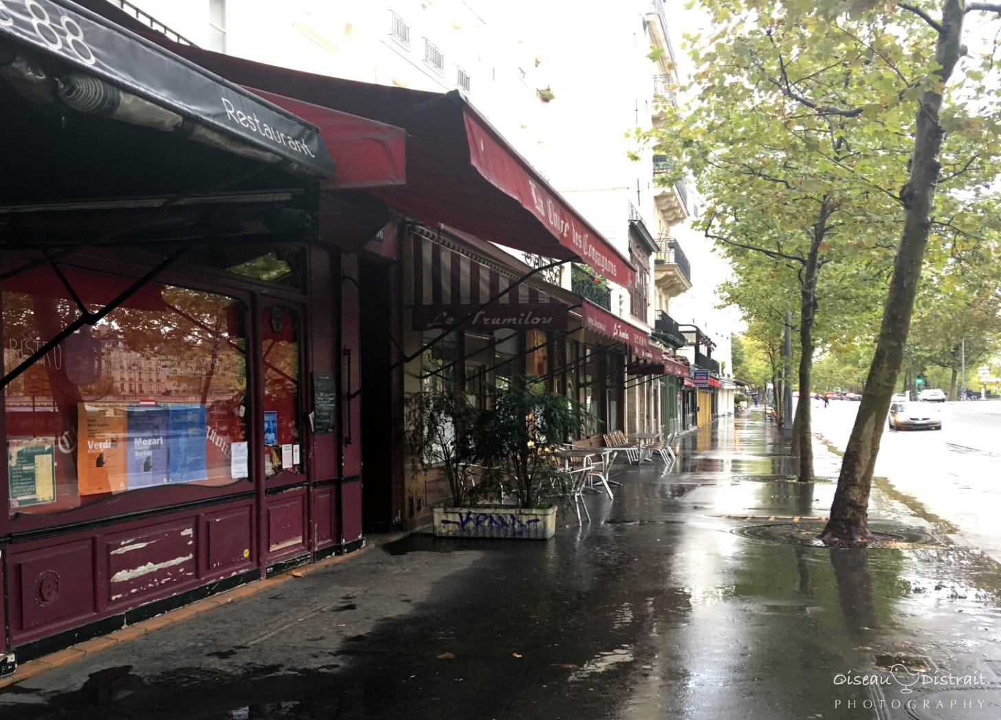A Paris road side café along a path after rain A Paris road side café along a path after rain