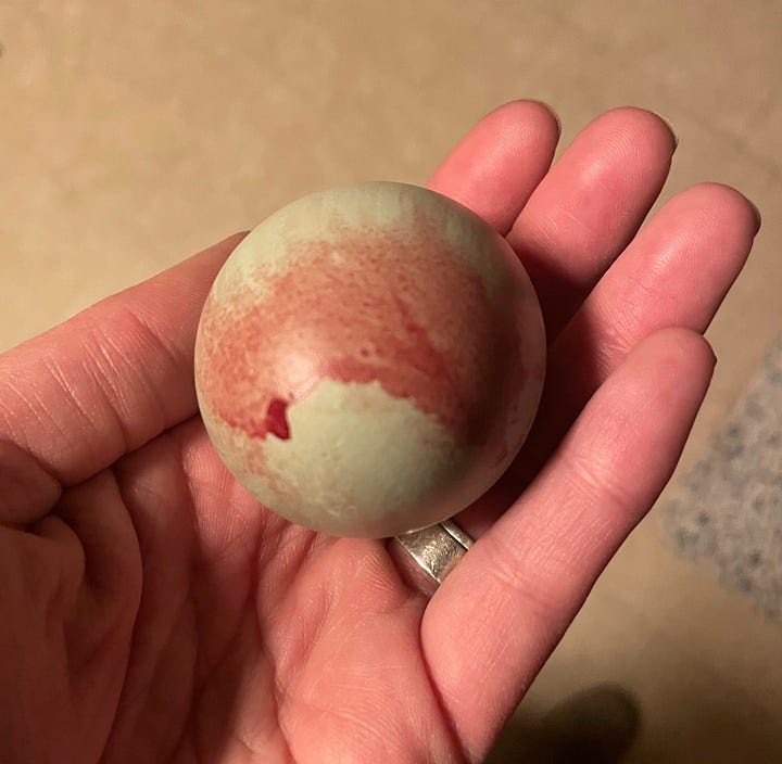 blue chicken egg with blood on the outer shell from laying trauma