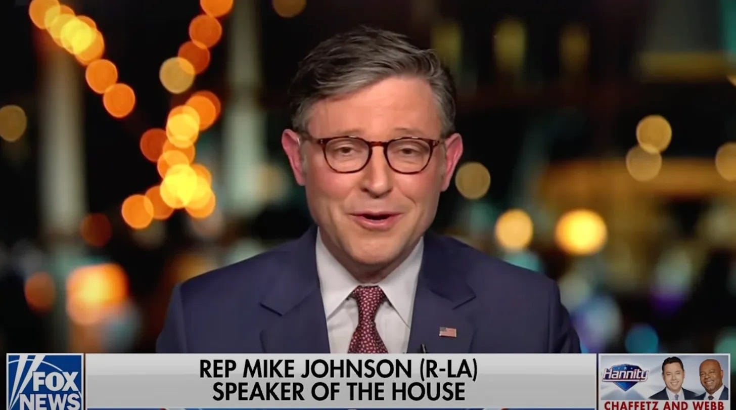 House Speaker Mike Johnson on Fox News, smiling smarmily. House Speaker Mike Johnson on Fox News, smiling smarmily.