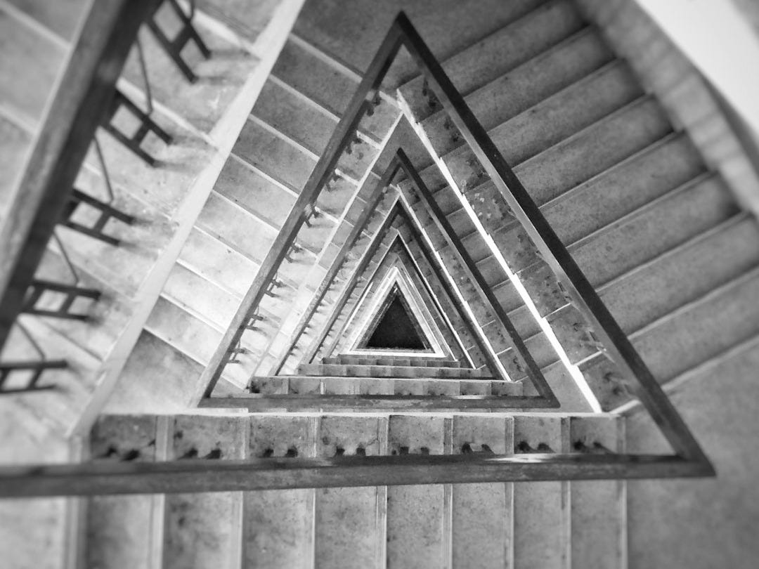 high-angle grayscale photography of triangular staircase