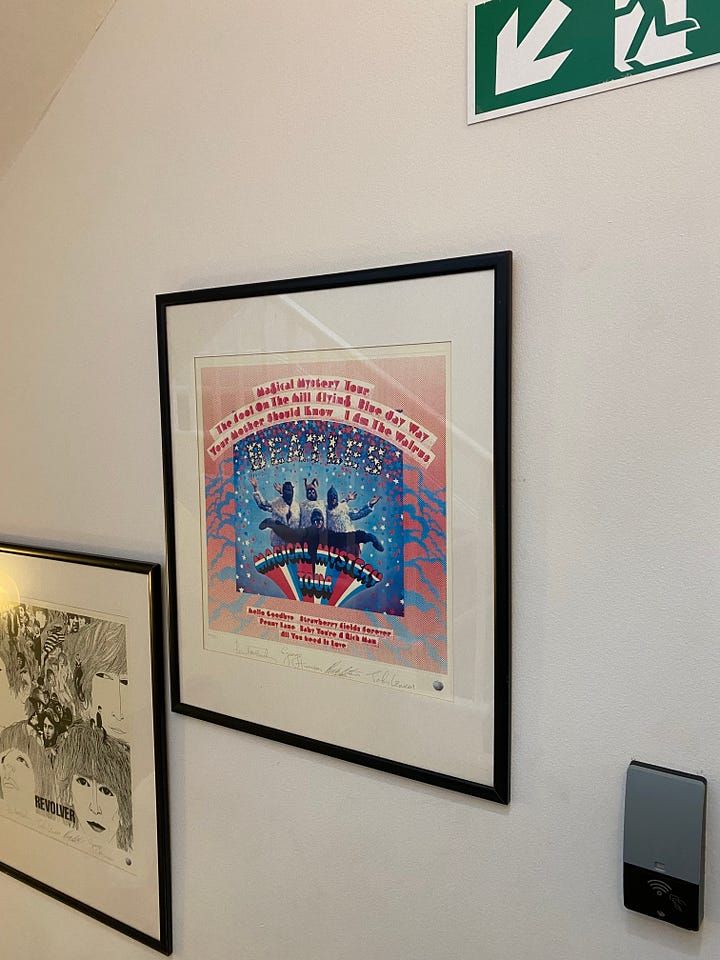 picture frames of Beatles album covers and photographs of Liam & Noel Gallagher and David Bowie.