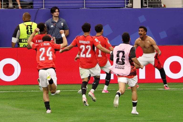 ARLINGTON, TEXAS - JULY 03: Hossam Abdelmaguid #4 of Egypt celebrates with teammates after scoring his team's fourth and winning penalty in the shootout during the FIFA World Cup 2026 Round Of 32 match between Australia and Egypt at Dallas Stadium on July 03, 2026 in Arlington, Texas. (Photo by Tullio Puglia - FIFA/FIFA via Getty Images) ARLINGTON, TEXAS - JULY 03: Hossam Abdelmaguid #4 of Egypt celebrates with teammates after scoring his team's fourth and winning penalty in the shootout during the FIFA World Cup 2026 Round Of 32 match between Australia and Egypt at Dallas Stadium on July 03, 2026 in Arlington, Texas. (Photo by Tullio Puglia - FIFA/FIFA via Getty Images)