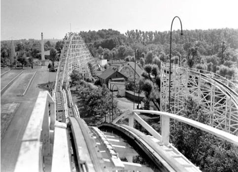 A roller coaster with trees and buildings
Description automatically generated A roller coaster with trees and buildings
Description automatically generated