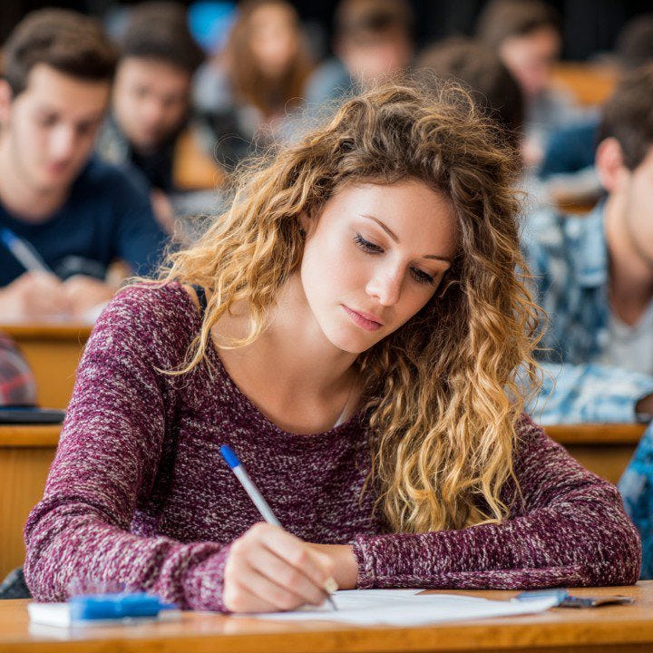 Student Writing in Notebook with Golden Pen - PresentationGO