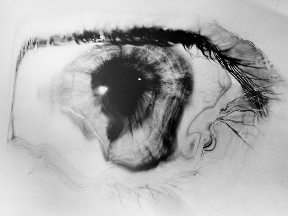 This may contain: an eye is shown in black and white