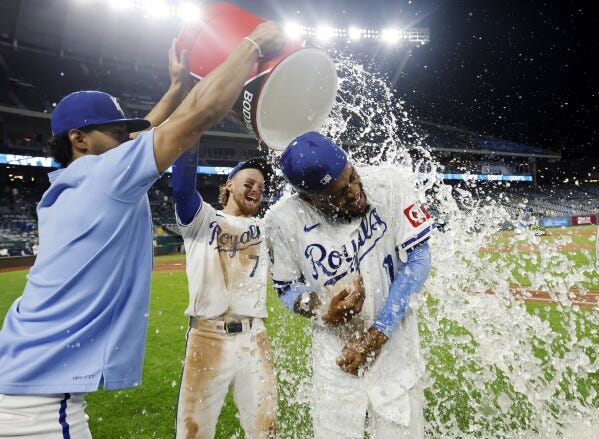 Kansas City Royals' Maikel Garcia, right, is doused by MJ Melendez, left, and Bobby Witt Jr. (7) at the end of a baseball game against the Milwaukee Brewers in Kansas City, Mo., Monday, May 6, 2024. (AP Photo/Colin E. Braley)