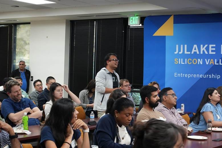 A group of people sitting in a room

AI-generated content may be incorrect.