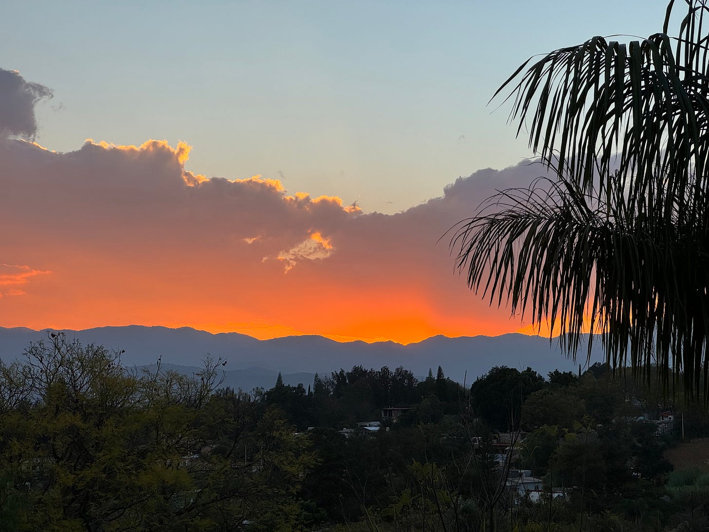 A photo of the sun setting over the hills in Oaxaca.