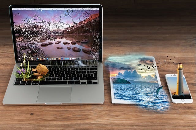 Laptop, tablet and mobile phone all showing vivid images which have escaped the confines of the screen Laptop, tablet and mobile phone all showing vivid images which have escaped the confines of the screen