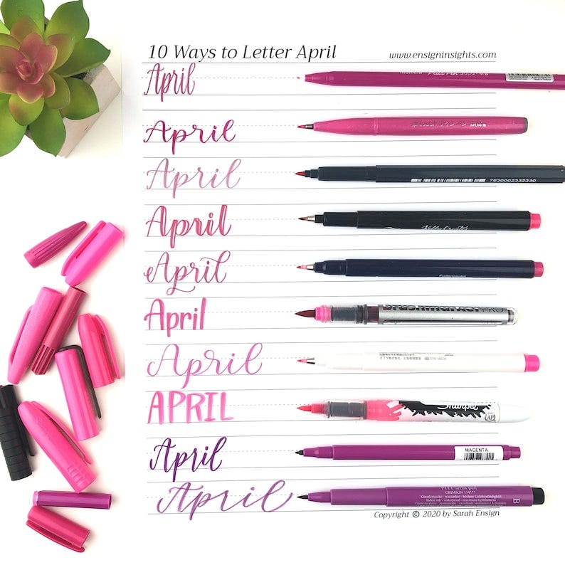 May include: 10 Ways to Letter April, a handwritten calligraphy guide with different styles of the word April written in pink and purple ink. The image shows a variety of pens and markers used for lettering.