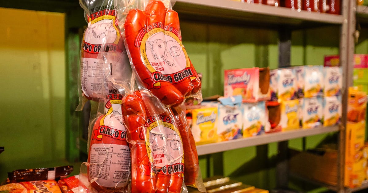 Estantes com alimentos processados expostos em mercadinho popular