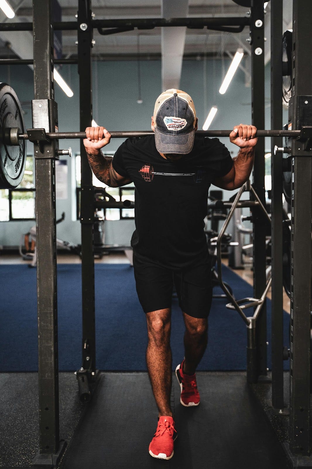 Man getting ready to squat at a squat bar