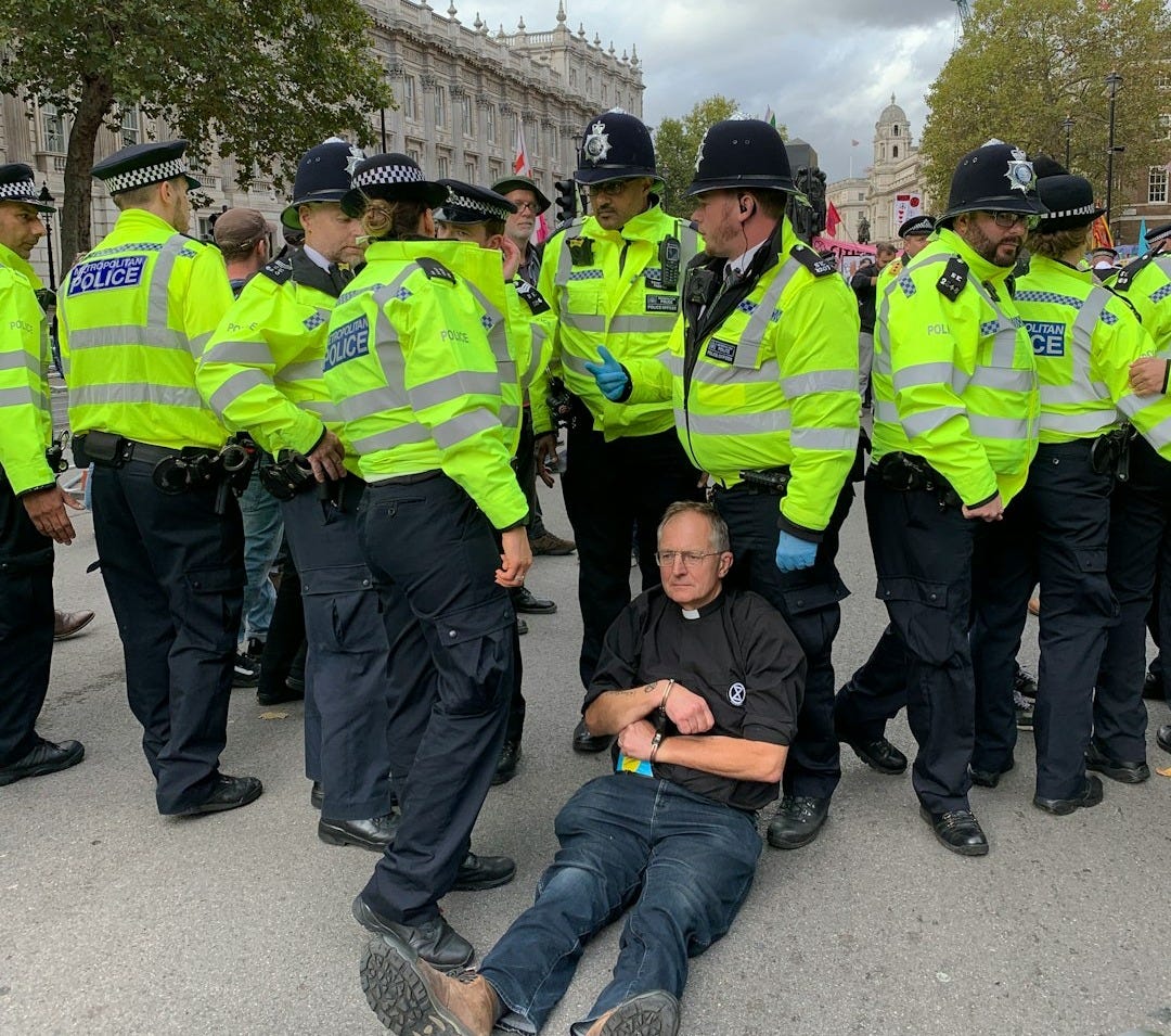 a man laying on the ground in front of police